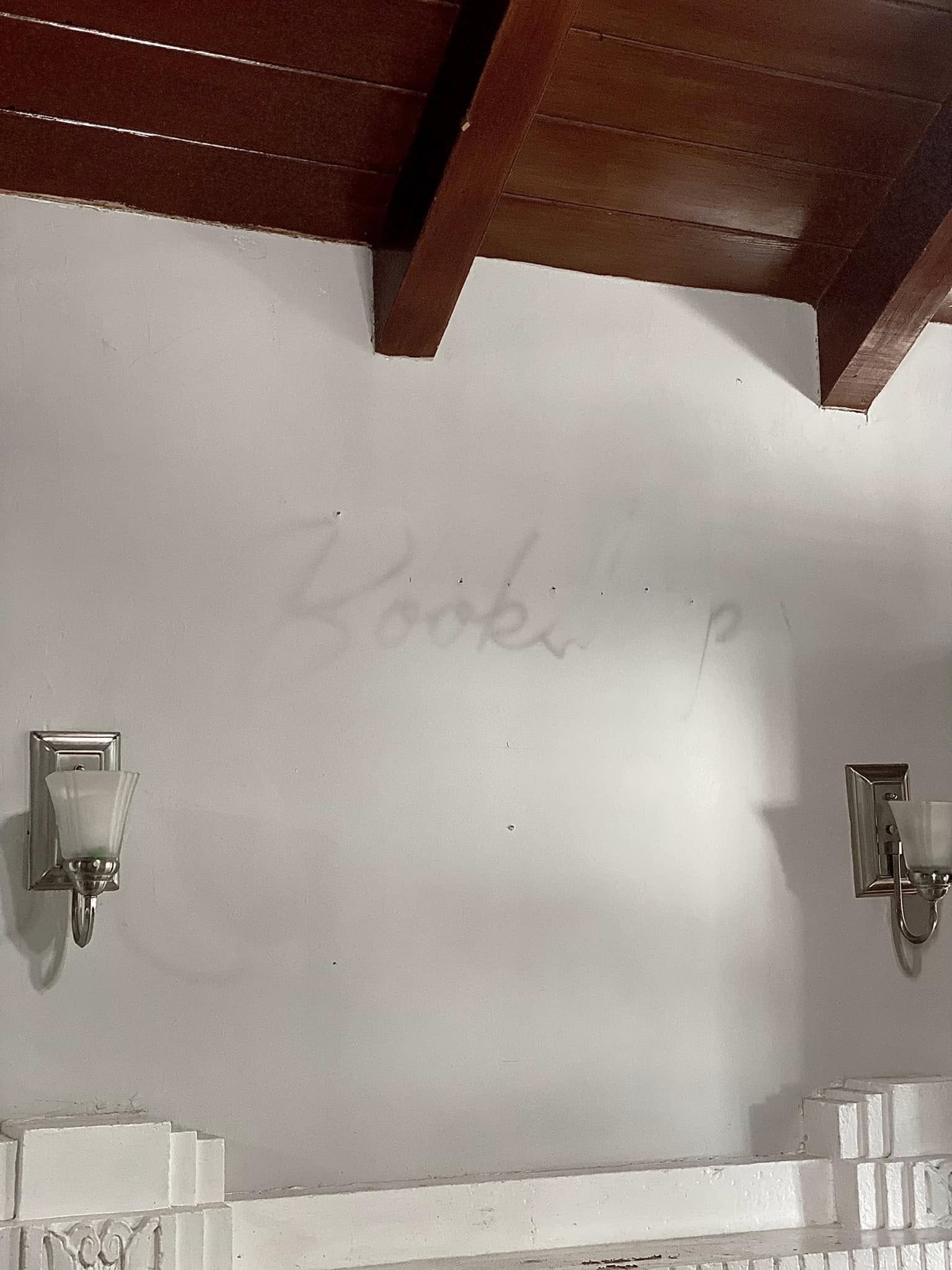 The outline of the Bookshop sign left on the wall after closing