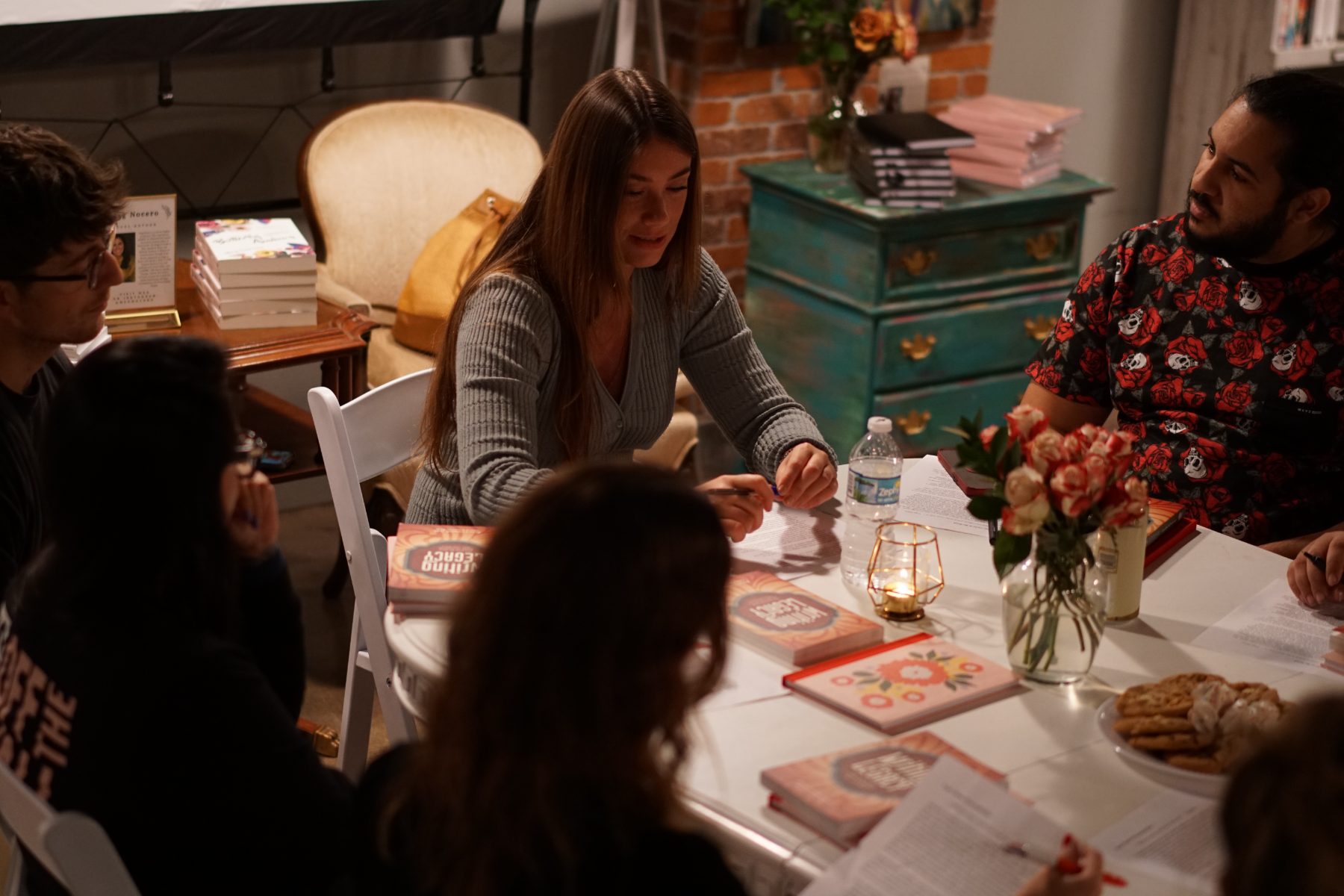 Tabitha Rose leading a writing workshop around a table