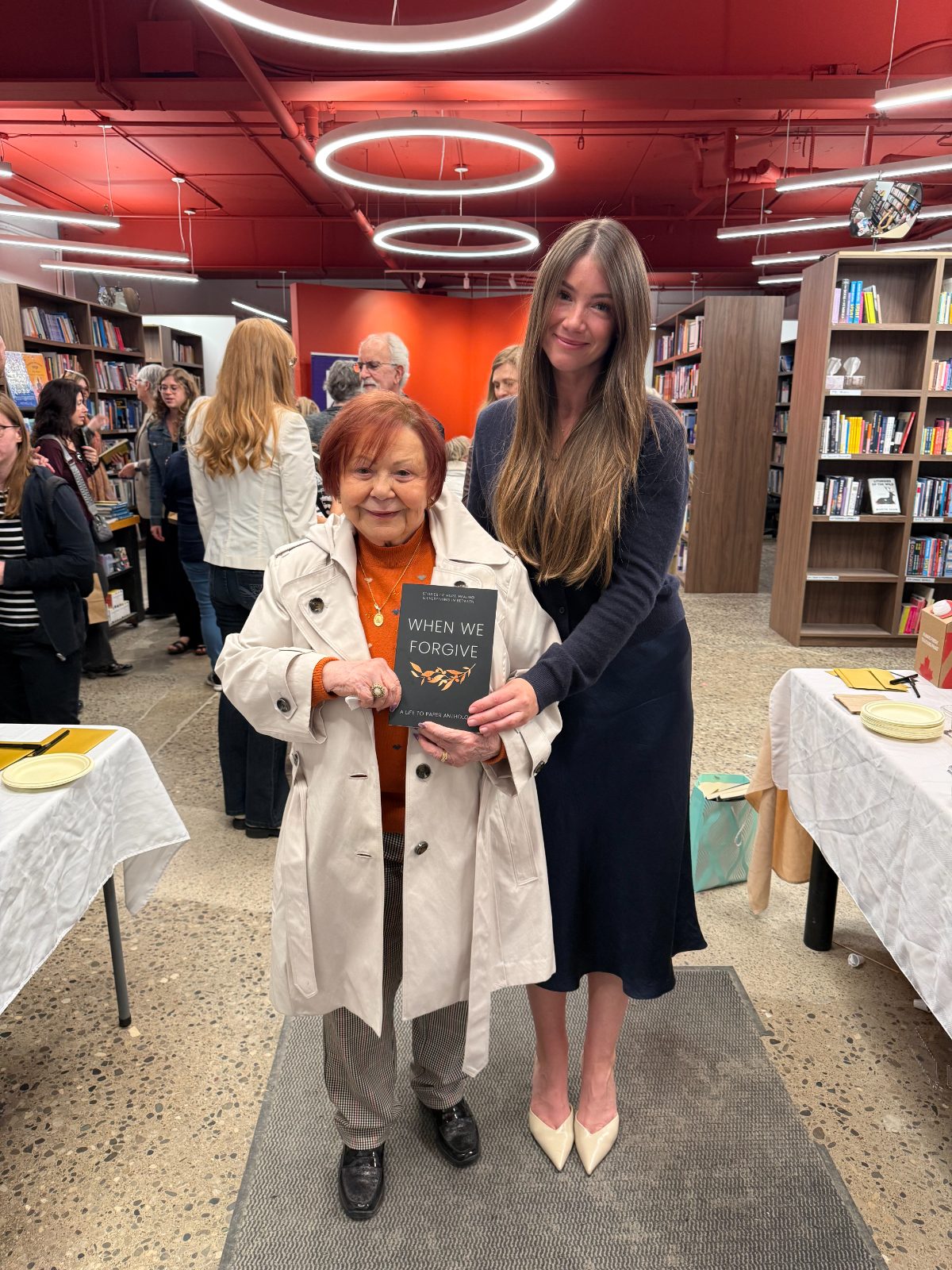 Tabitha and her grandmother, Eva, holding When We Forgive at the book launch
