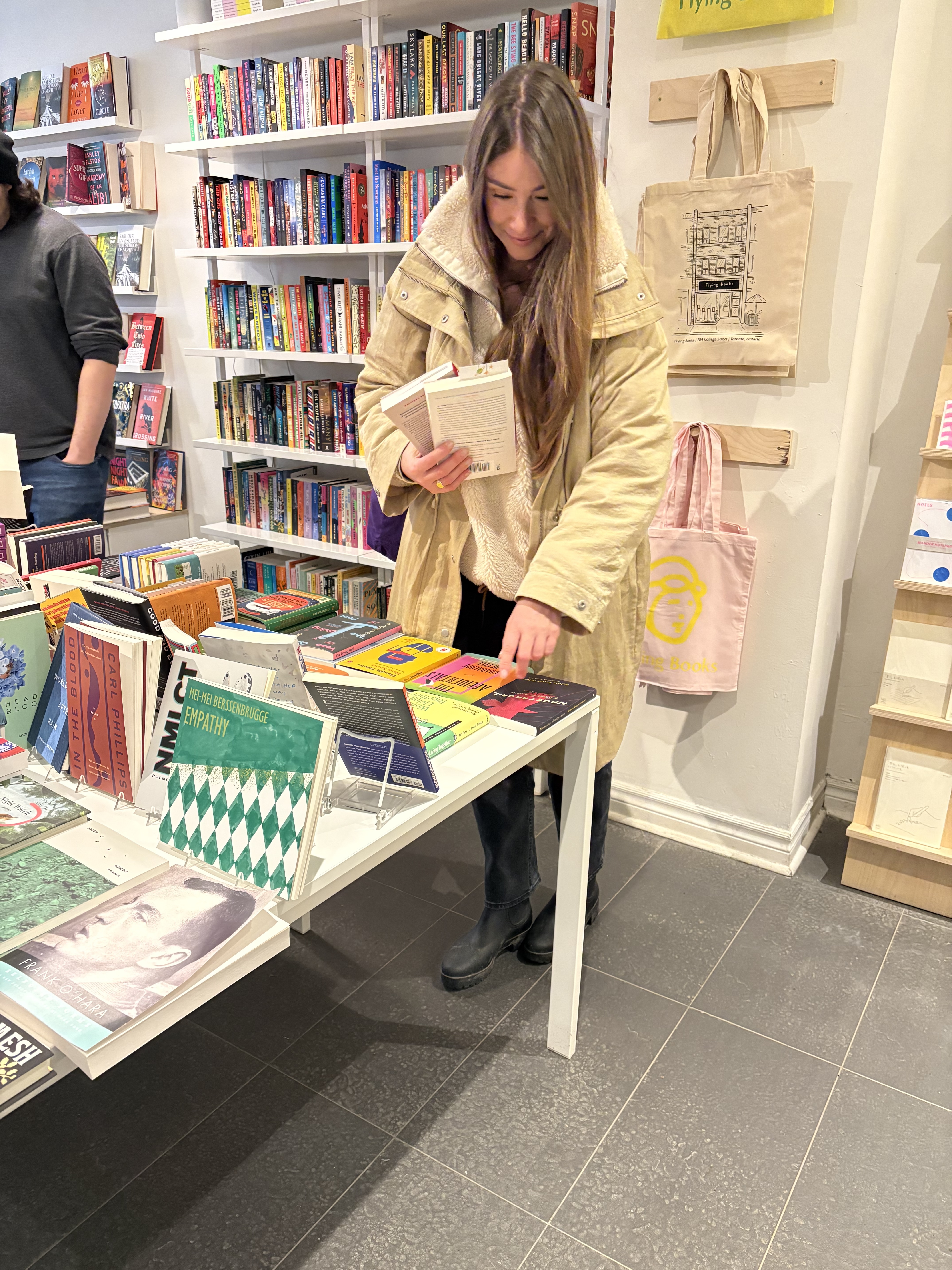 Tabitha browsing books at a bookstore