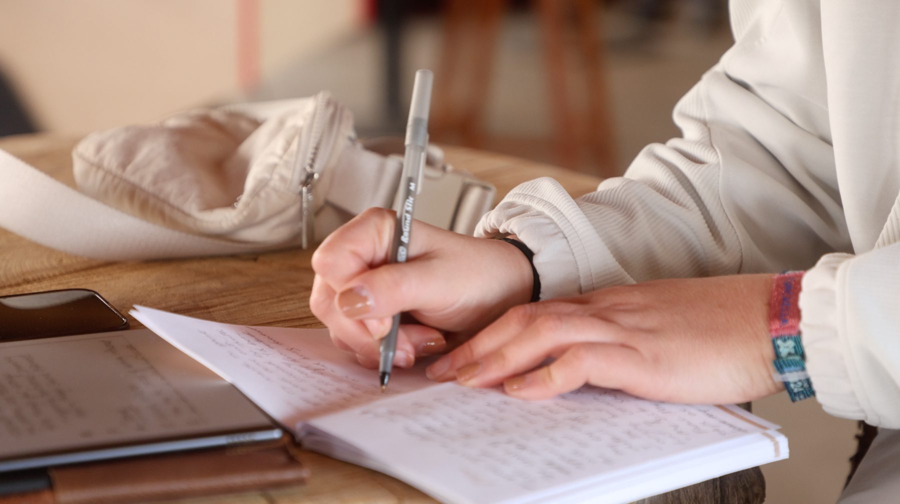 A workshop participant writing in a notebook