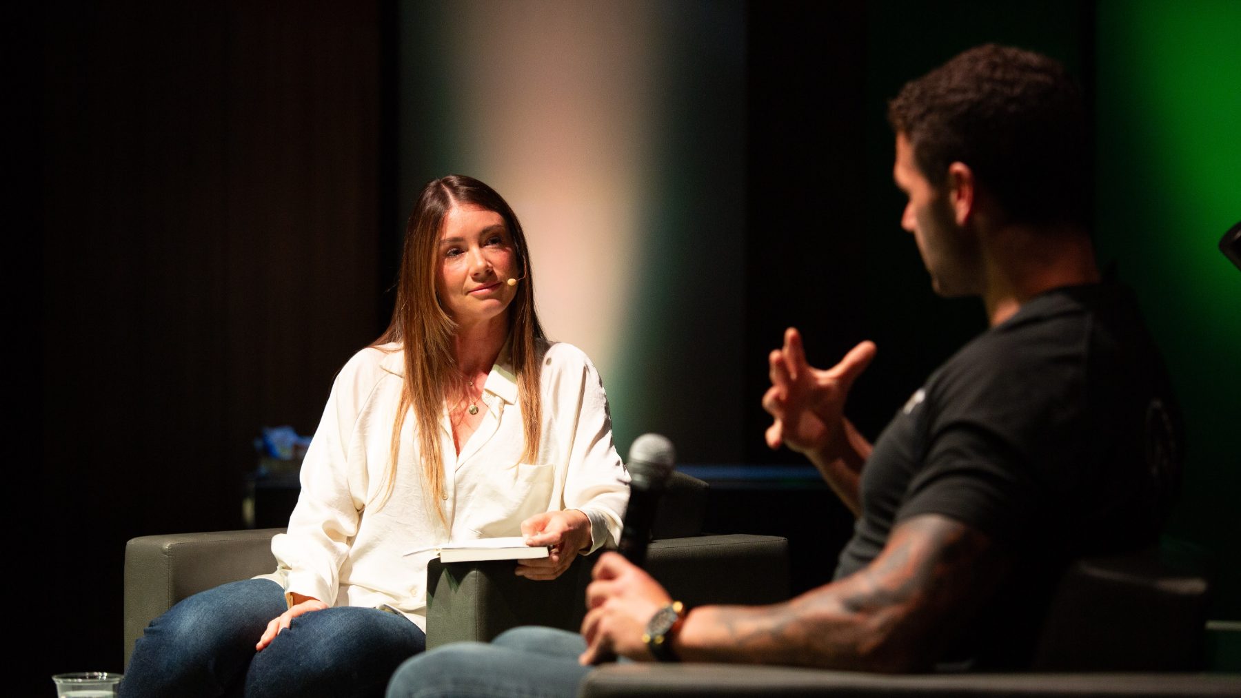 Tabitha in conversation with an author on stage